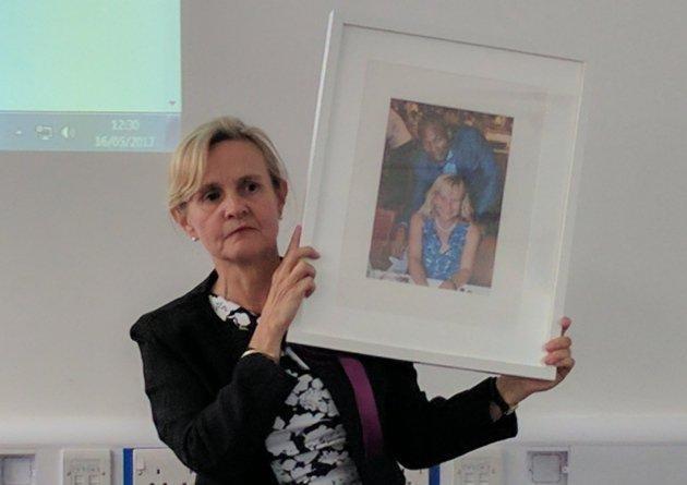 Catherine Blaiklock holds up a photograph of her husband