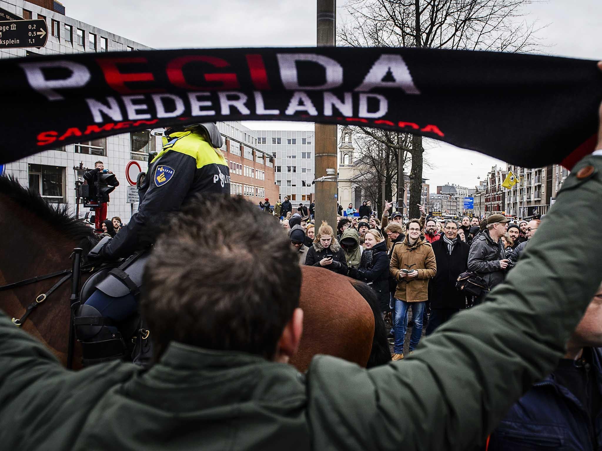 Members of Pegida face counter-protesters during a demonstration in central Amsterdam