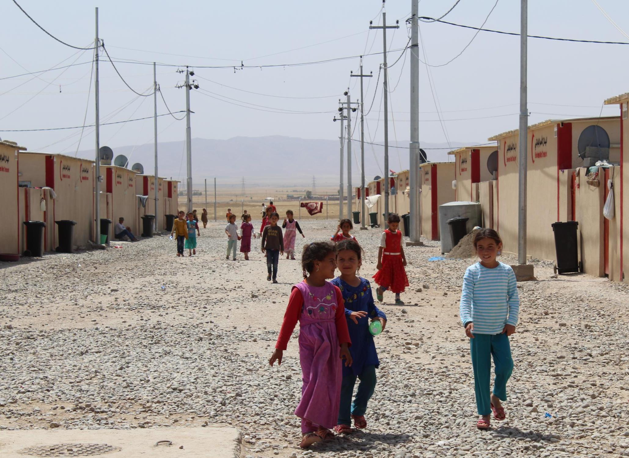 Children take advantage of their lunch break to play and wander the streets in Dibaga 2 IDP camp, south of Mosul, on 9 May 2017 