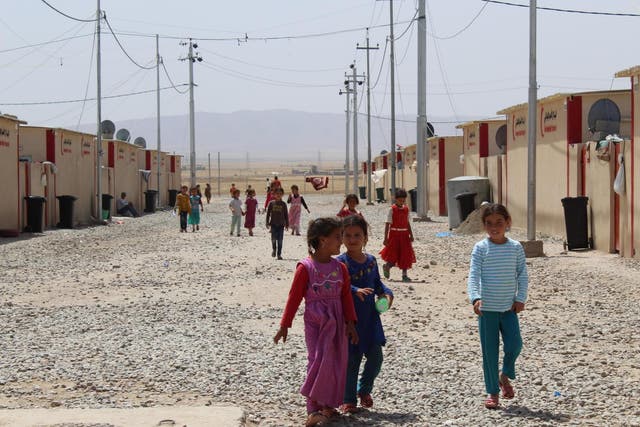 Children take advantage of their lunch break to play and wander the streets in Dibaga 2 IDP camp, south of Mosul, on 9 May 2017 