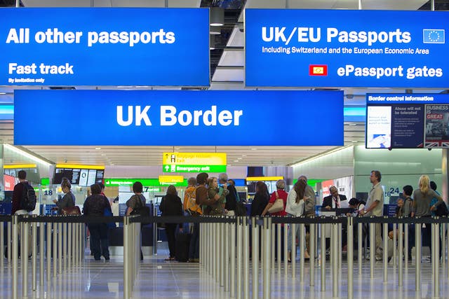 <p>Passengers pass through border control at Heathrow Airport</p>