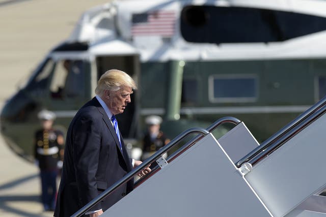 President Donald Trump walks up the steps of Air Force One at Andrews Air Force Base on Wednesday