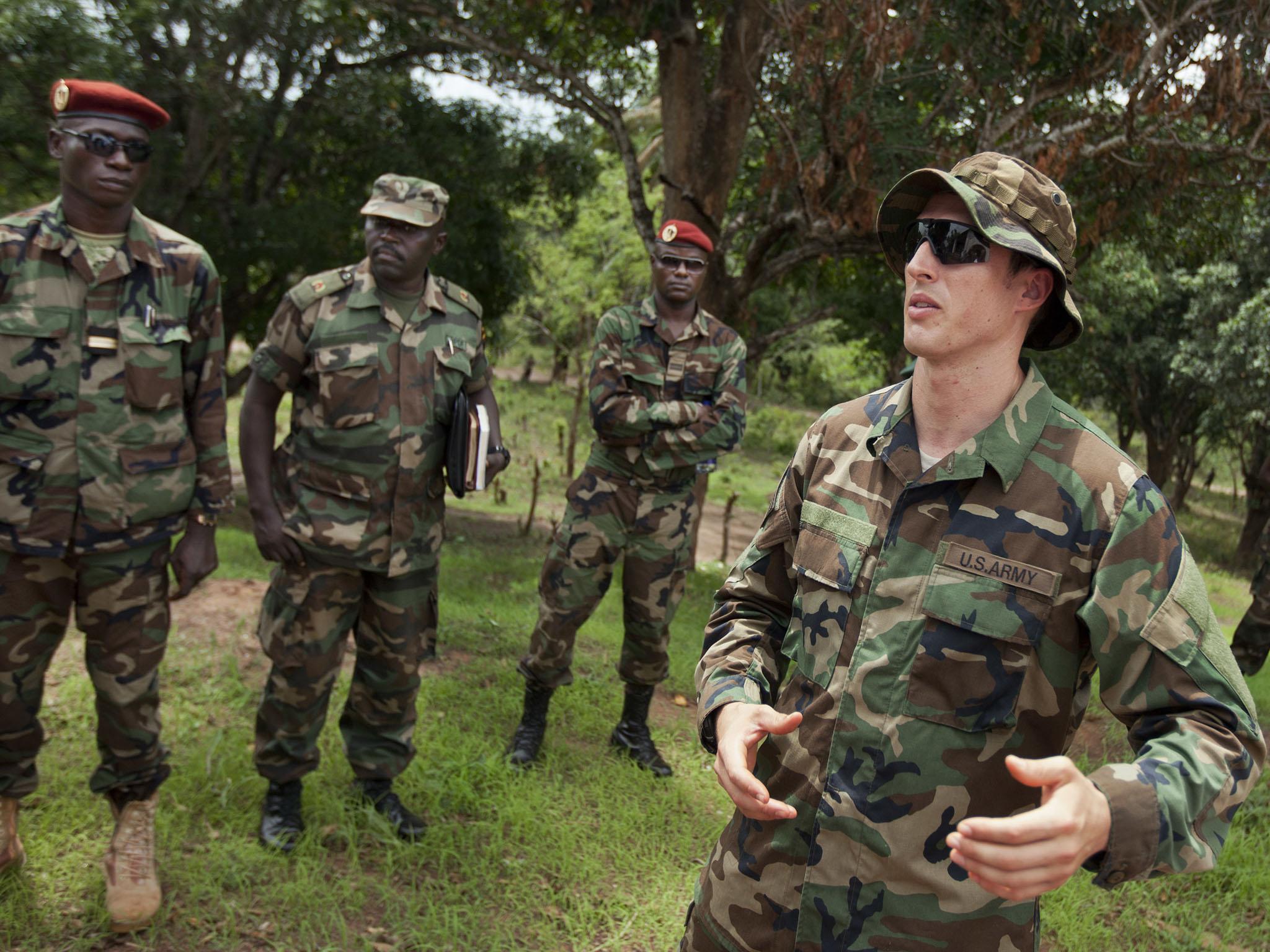US Army Captain Gregory, 29, from Texas, right, speaks with troops from the Central African Republic and Uganda