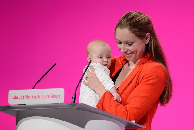 Catherine Atkinson, pictured with her then 3-month-old son in 2014, was confronted by a Tory councillor over her suitability to be an MP while pregnant with her second child