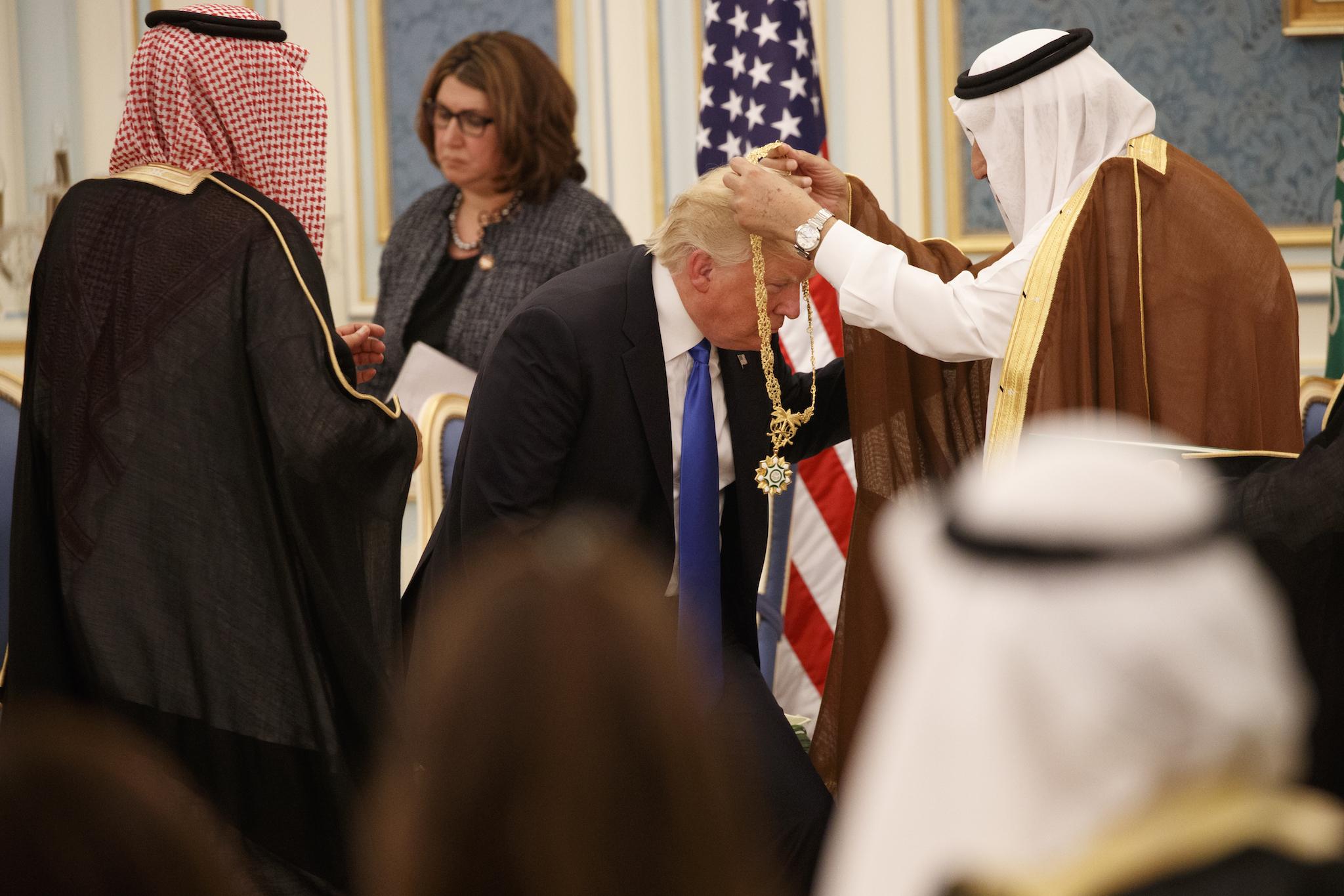 Saudi King Salman presents President Donald Trump with The Collar of Abdulaziz Al Saud Medal at the Royal Court Palace
