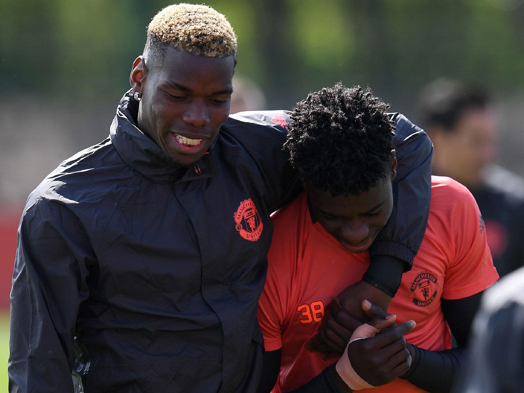 Axel Tuanzebe with first-team player Paul Pogba