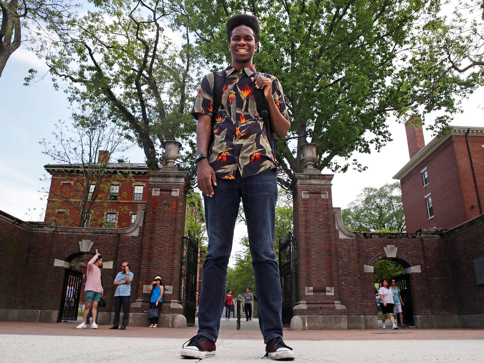 Obasi Shaw poses outside the gates of Harvard Yard/