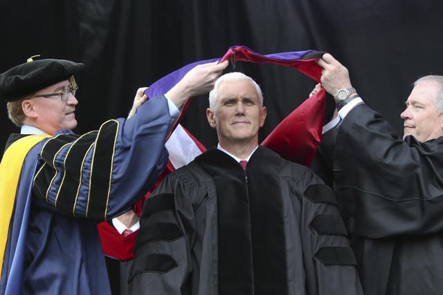 Vice President Mike Pence receives a sash representing an honorary degree at Grove City College, the day before giving a commencement address at Notre Dame University