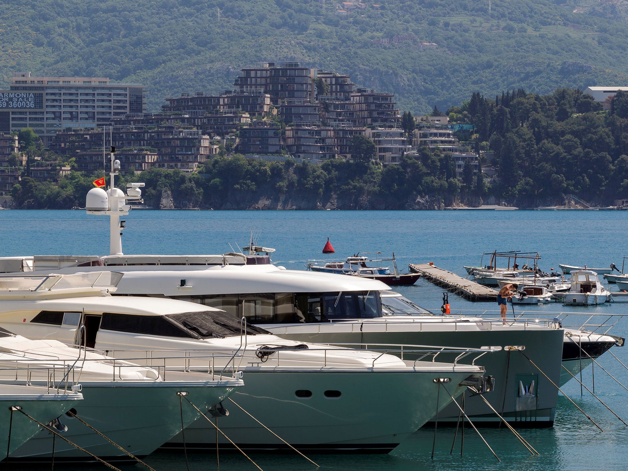 Newly built real estate behind luxury yachts in Budva, Montenegro