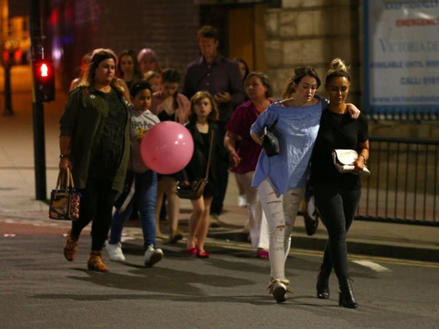 Members of the public are escorted from the Manchester Arena on May 23, 2017