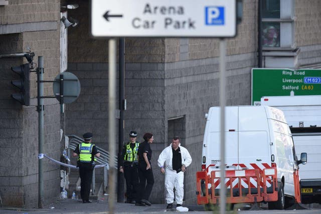 Members of the emergency services work near Manchester Arena following a terror attack at an Ariana Grande concert