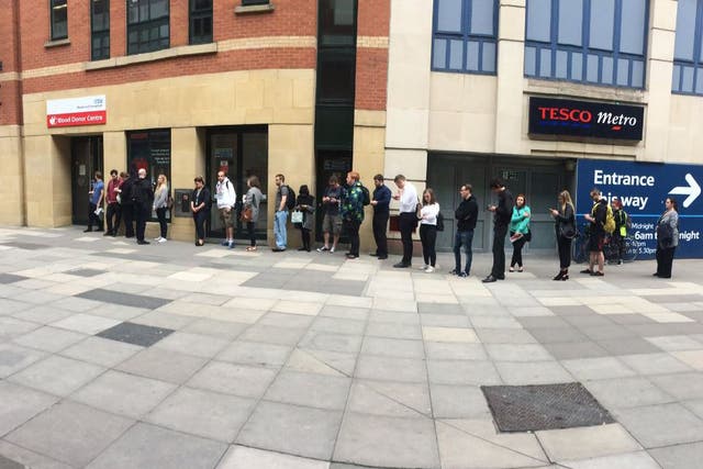 People queue to give blood at a donation centre in Manchester the morning after the attac