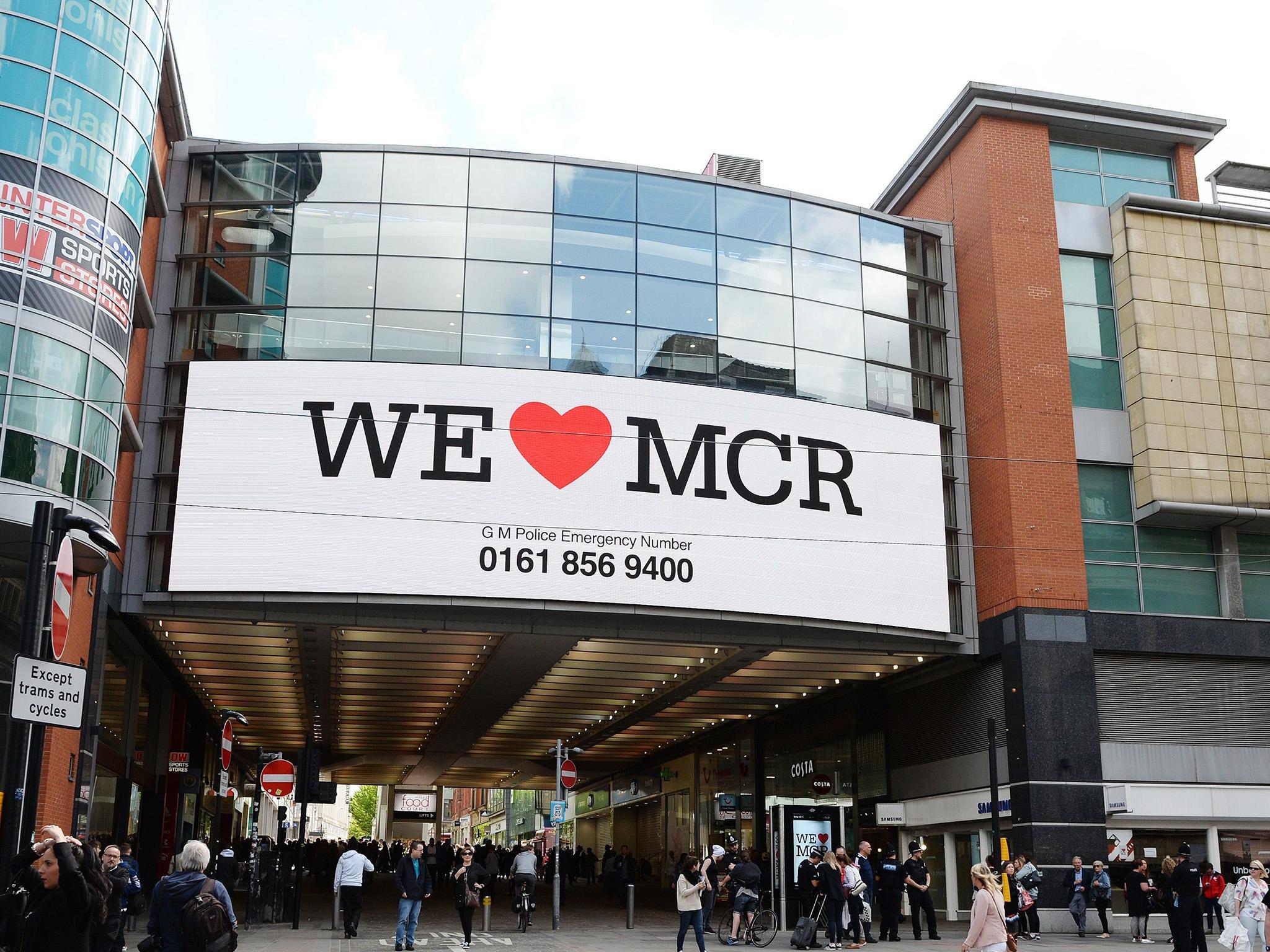 Banners with the message "We Love MCR" are being displayed across the city after last night's atrocity
