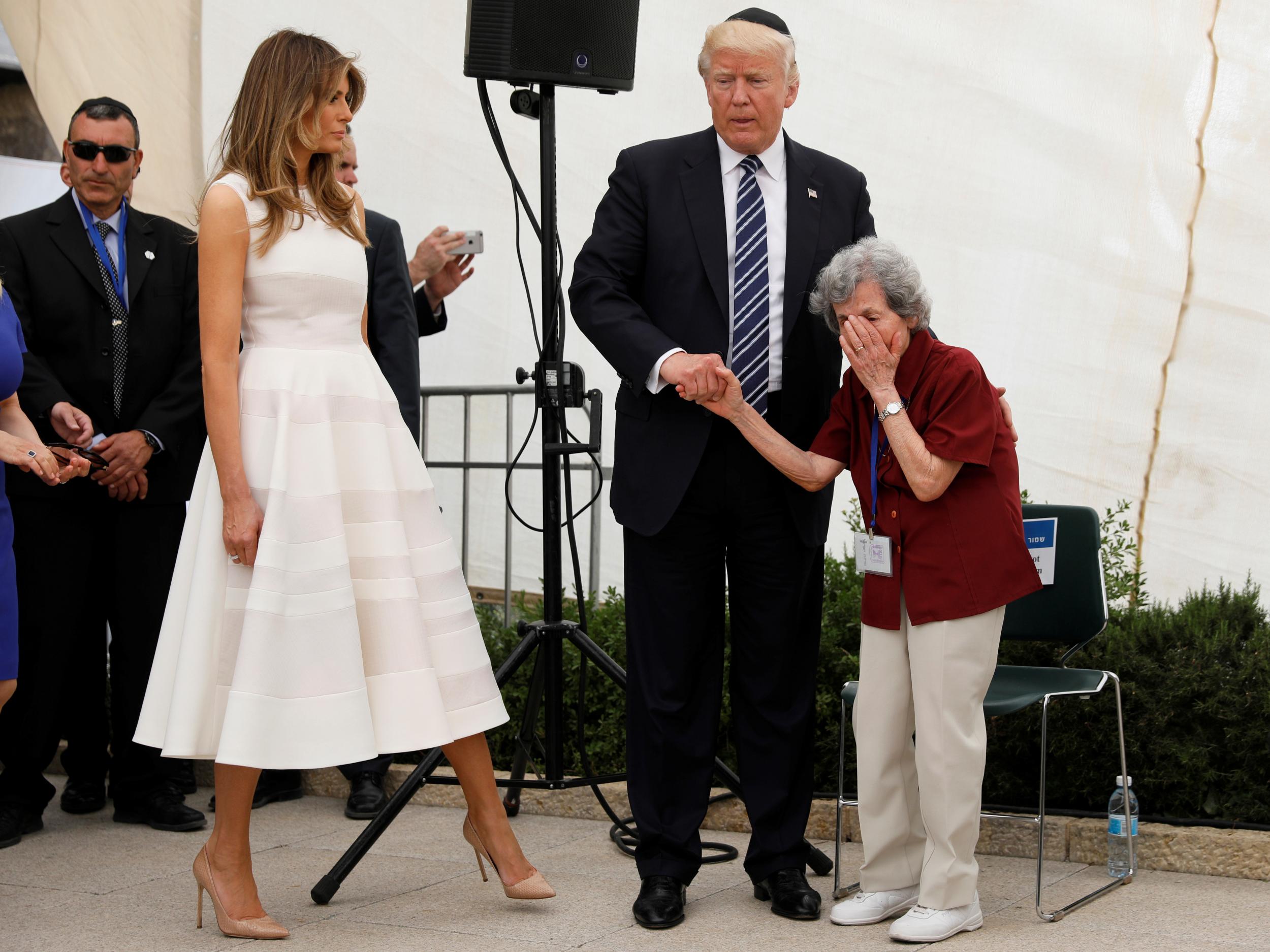 US President Donald Trump holds the hand of Holocaust survivor Margot Goldstein