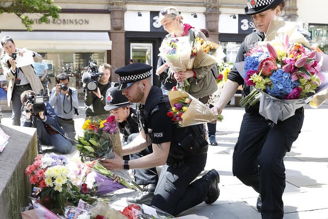 Flowers are left in St Ann's Square, Manchester, the day after a suicide bomber killed 22 people, including children