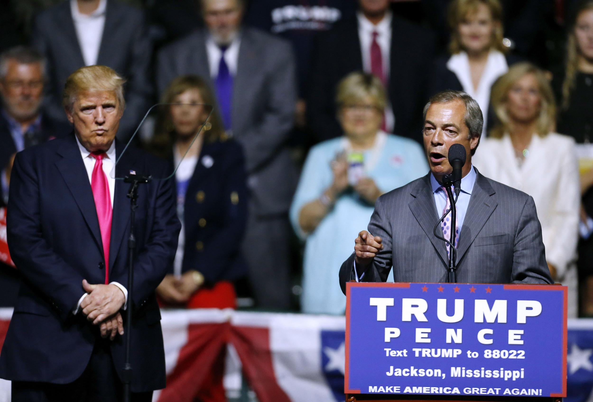 Donald Trump looks on as Nigel Farage speaks for him at a 2016 campaign event