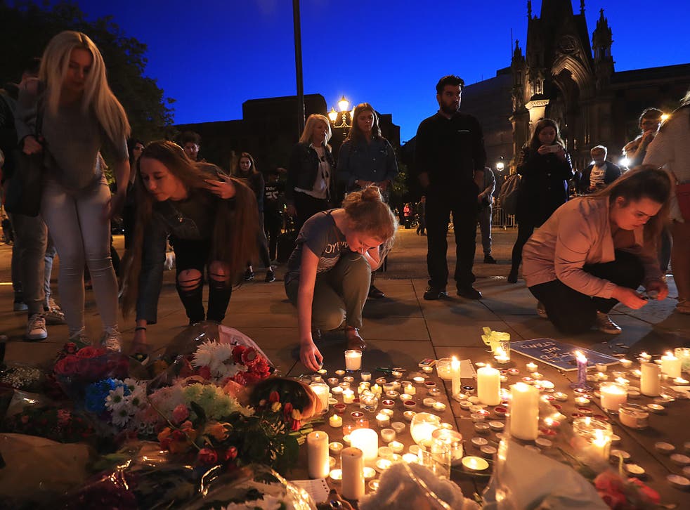 People leave tributes to victims of the Manchester concert bomb attack in Albert Square, Manchester