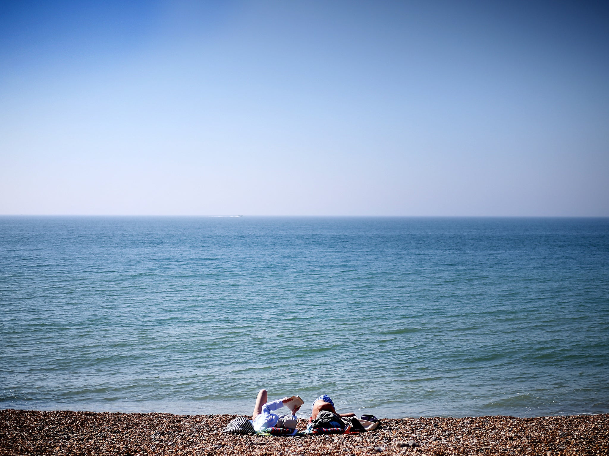 Couple relax on Brighton beach
