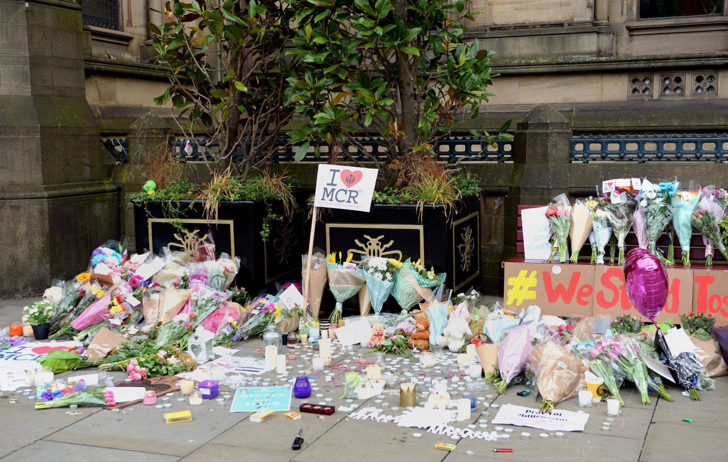 Floral tributes left by Manchester Town Hall after a suicide bomber killed 22 people leaving a pop concert at the Manchester Arena on Monday night