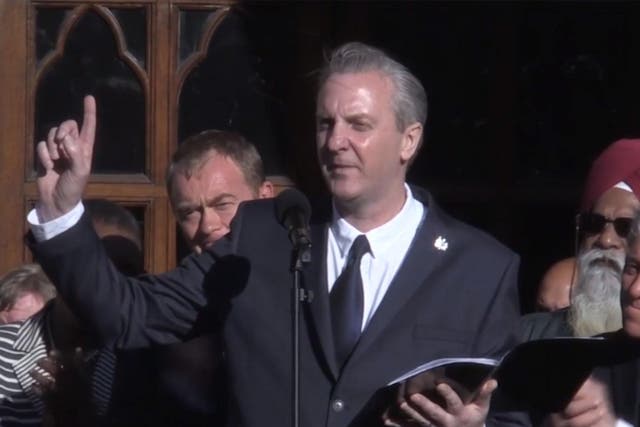 The poet Tony Walsh delivers his poem to a crowd of people at central Albert Square/