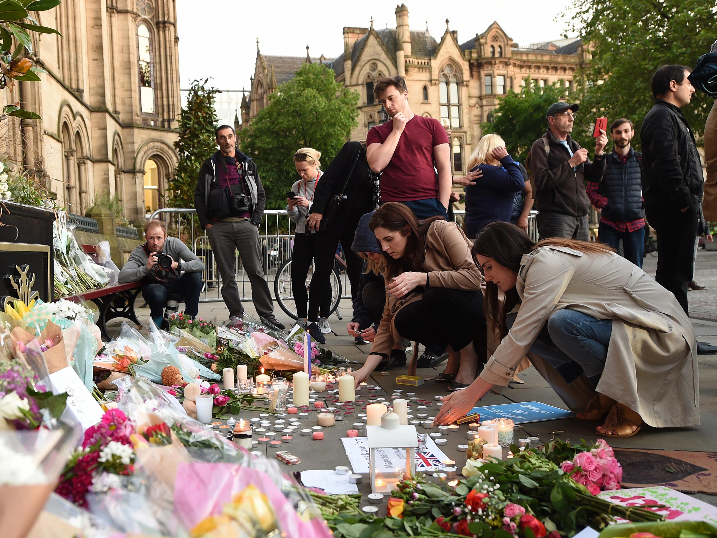 People leave tributes to victims of the Manchester concert bomb attack in Albert Square in the city centre