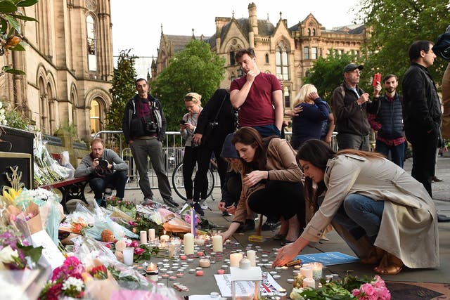 People leave tributes to victims of the Manchester concert bomb attack in Albert Square in the city centre