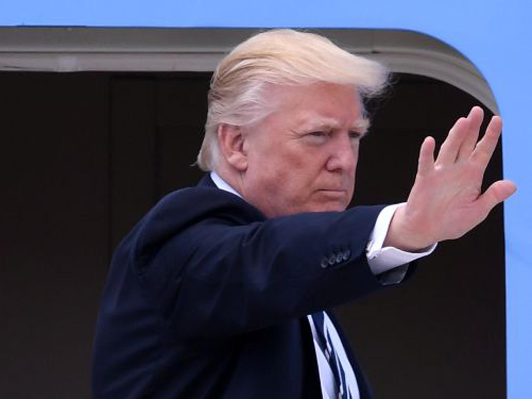 Donald Trump waves before boarding Air Force One