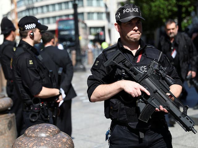 Armed police officers stand on duty outside St Paul's Cathedral in London