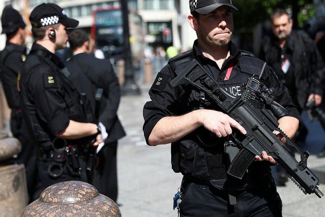 Armed police officers stand on duty outside St Paul's Cathedral in London