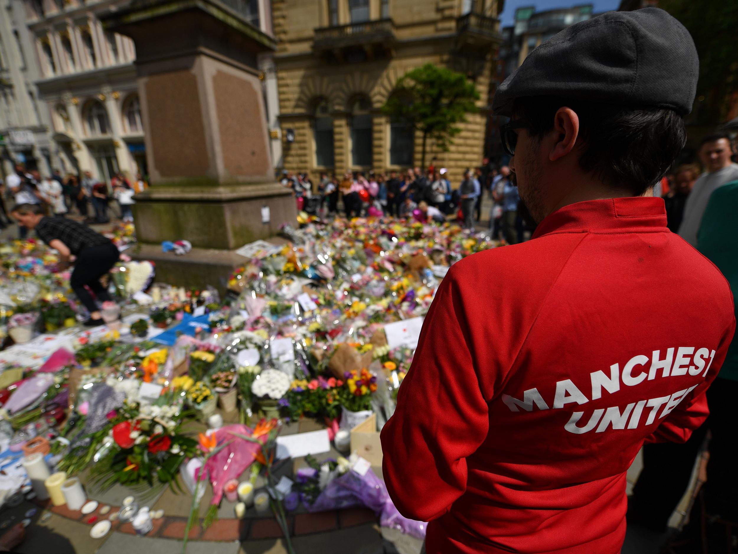 A Manchester United fan pays his respects ahead of kick-off