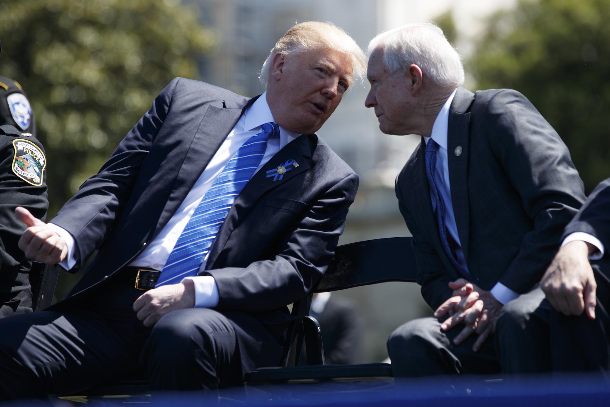 Attorney General Jeff Sessions talks to President Donald Trump