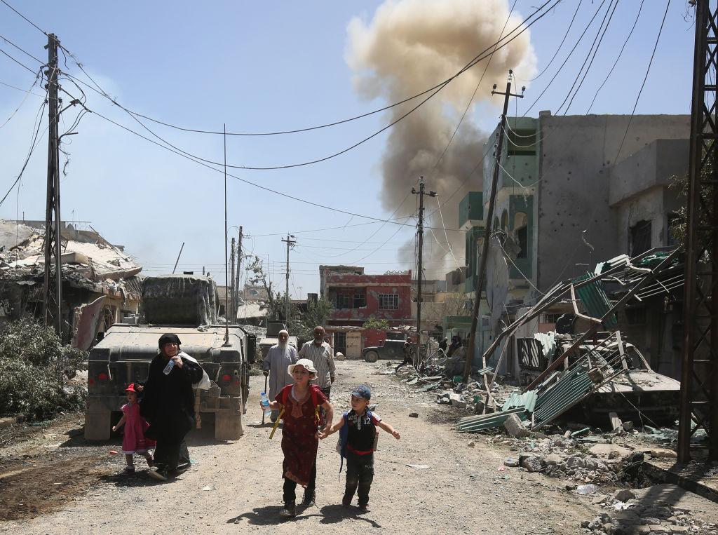 Displaced Iraqis flee their homes in west Mosul on 17 May as security forces advance during the ongoing offensive against Isis (AFP/Getty Images)