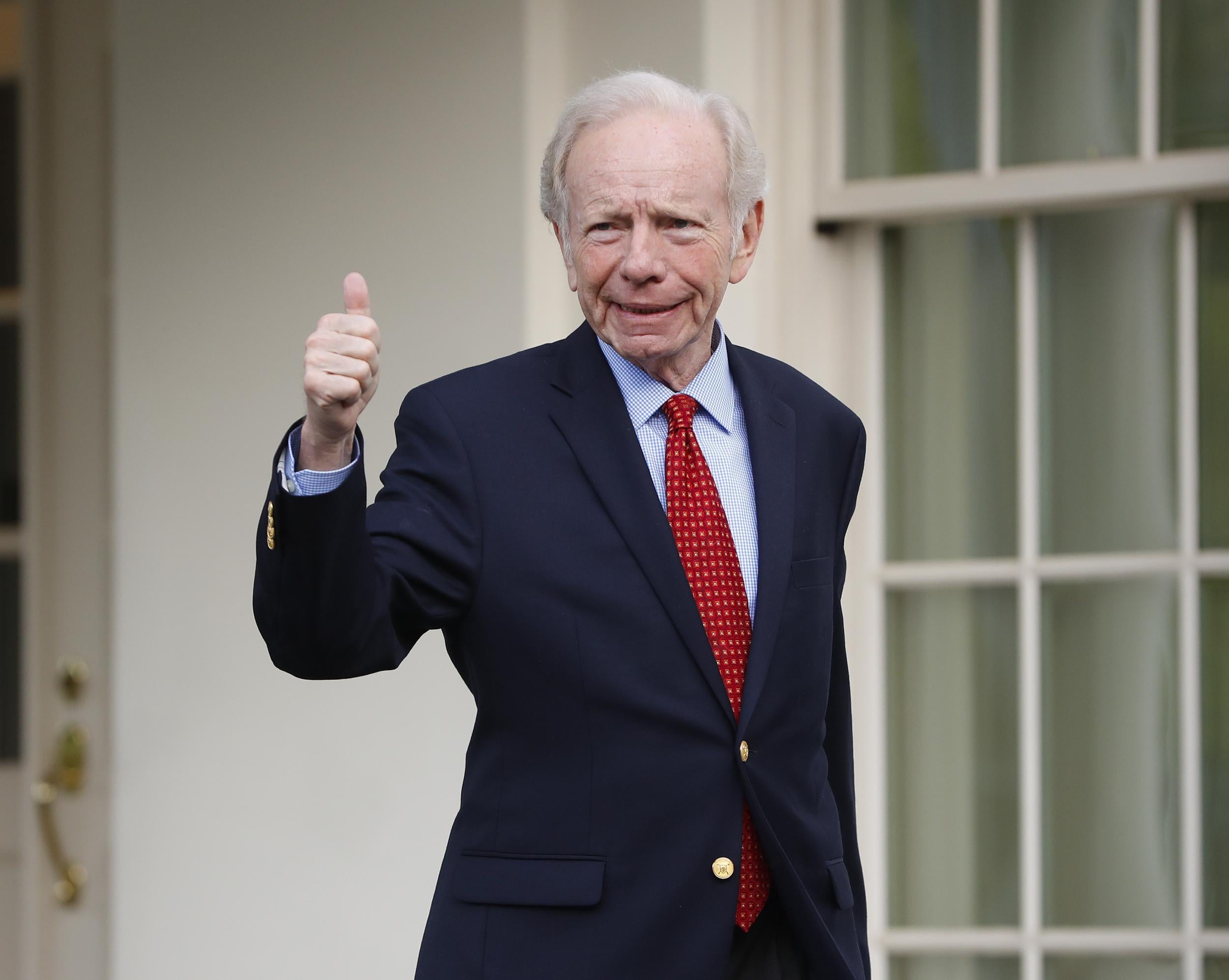 Former Connecticut Sen. Joe Lieberman gives a 'thumbs-up' as he leaves the West Wing of the White House