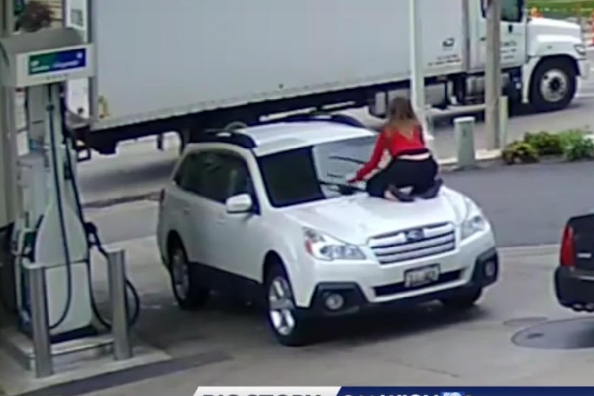 Woman jumps onto the hood of moving car to prevent carjacking at petrol ...