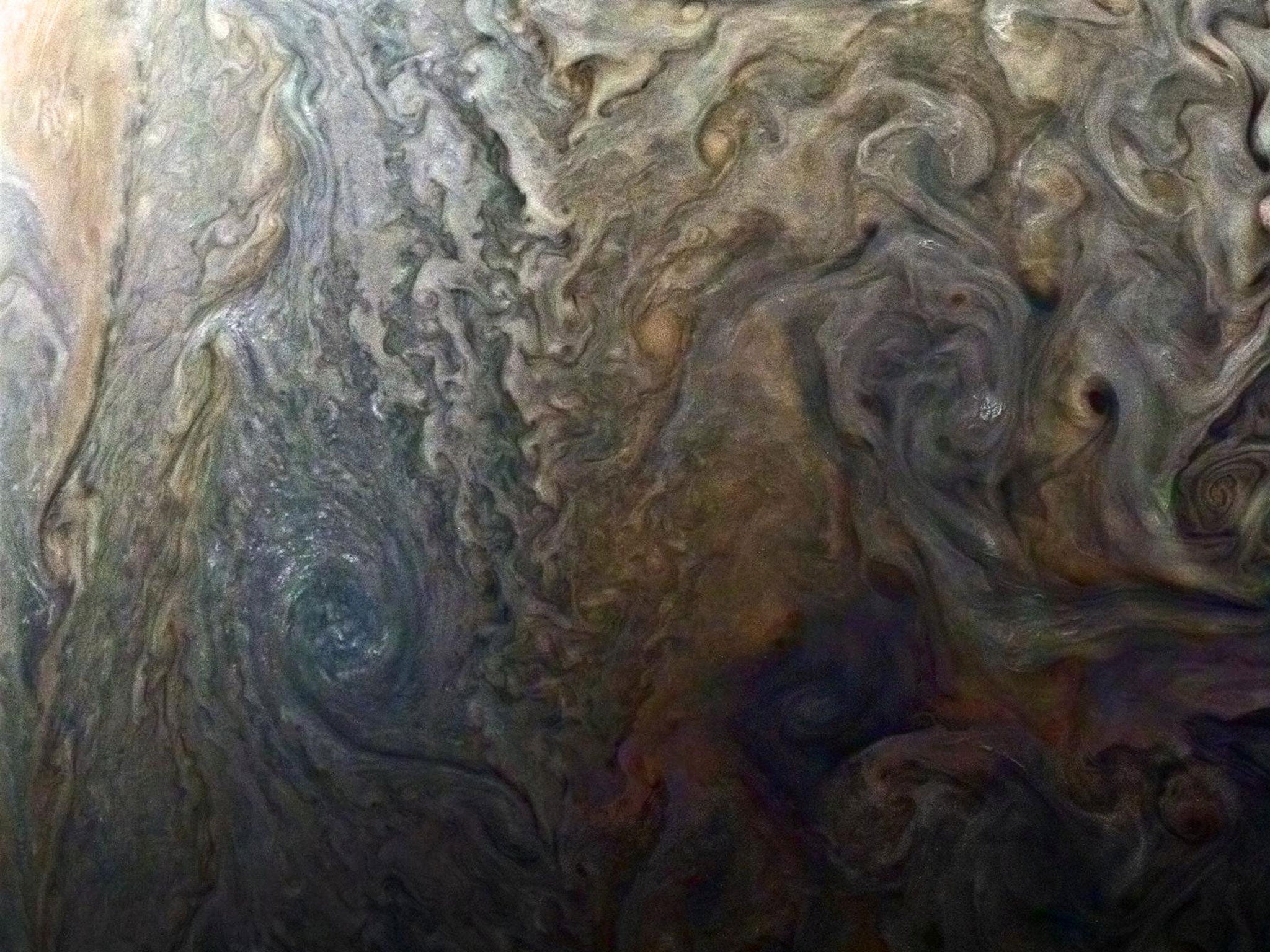 Nasa's enhanced-colour image of a mysterious dark spot on Jupiter shows a Jovian 'galaxy' of swirling storms