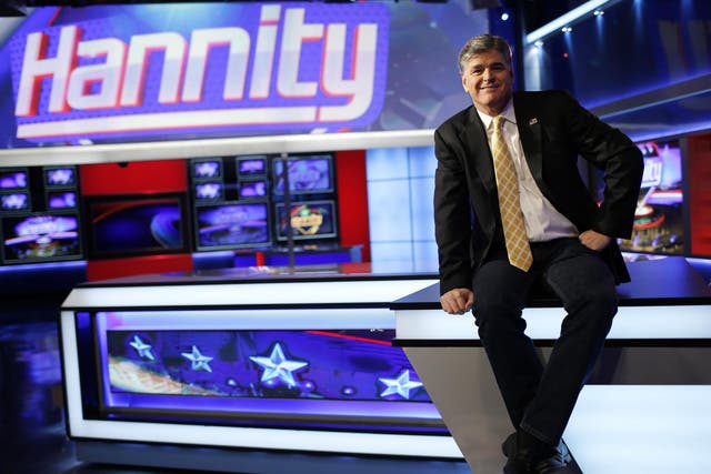 Fox News Channel anchor Sean Hannity poses for photographs on the set of his show during happier times