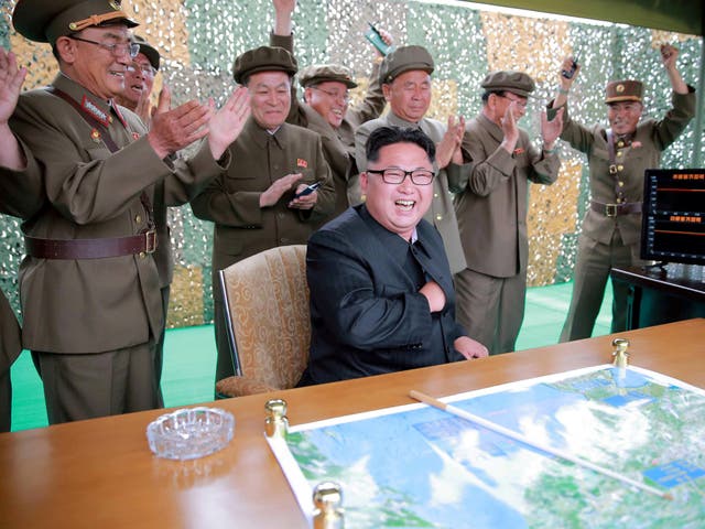 Kim Jong-un and his entourage including Ri Pyong-chol (centre, back row) and Jang Chang-ha (right) react with delight to the successful test launch of a Hwasong-1 ground-to-ground medium long-range ballistic rocket