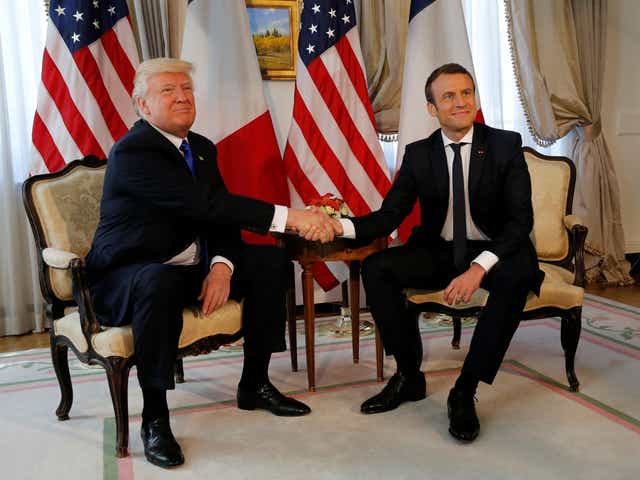 US President Donald Trump and French President Emmanuel Macron shake hands before a lunch ahead of a Nato Summit in Brussels