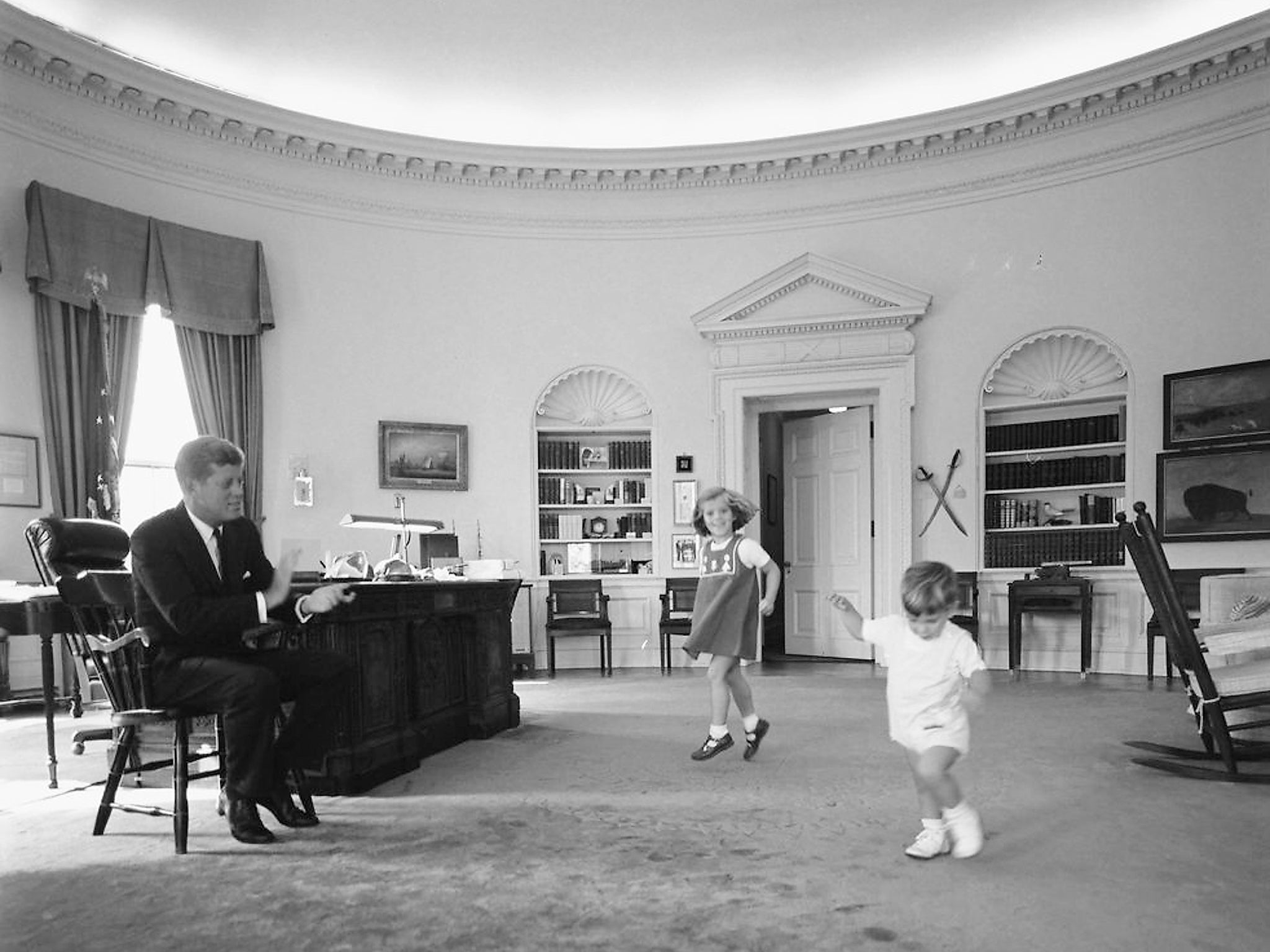Kennedy with his daughter Caroline and son John in the Oval Office in the White House in October 1962