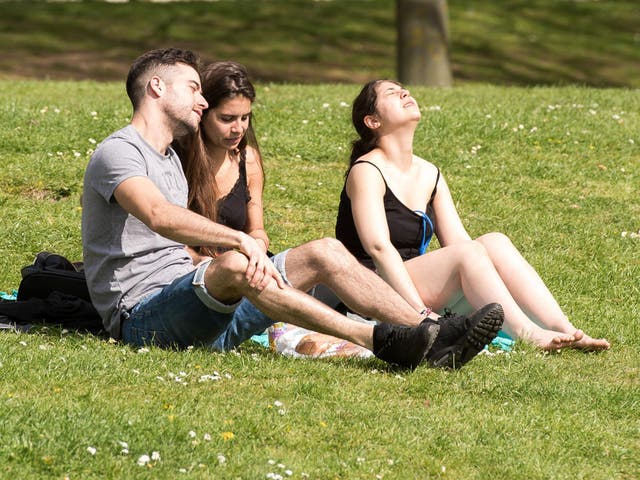 People bask in the sunshine in Castle Park, Bristol