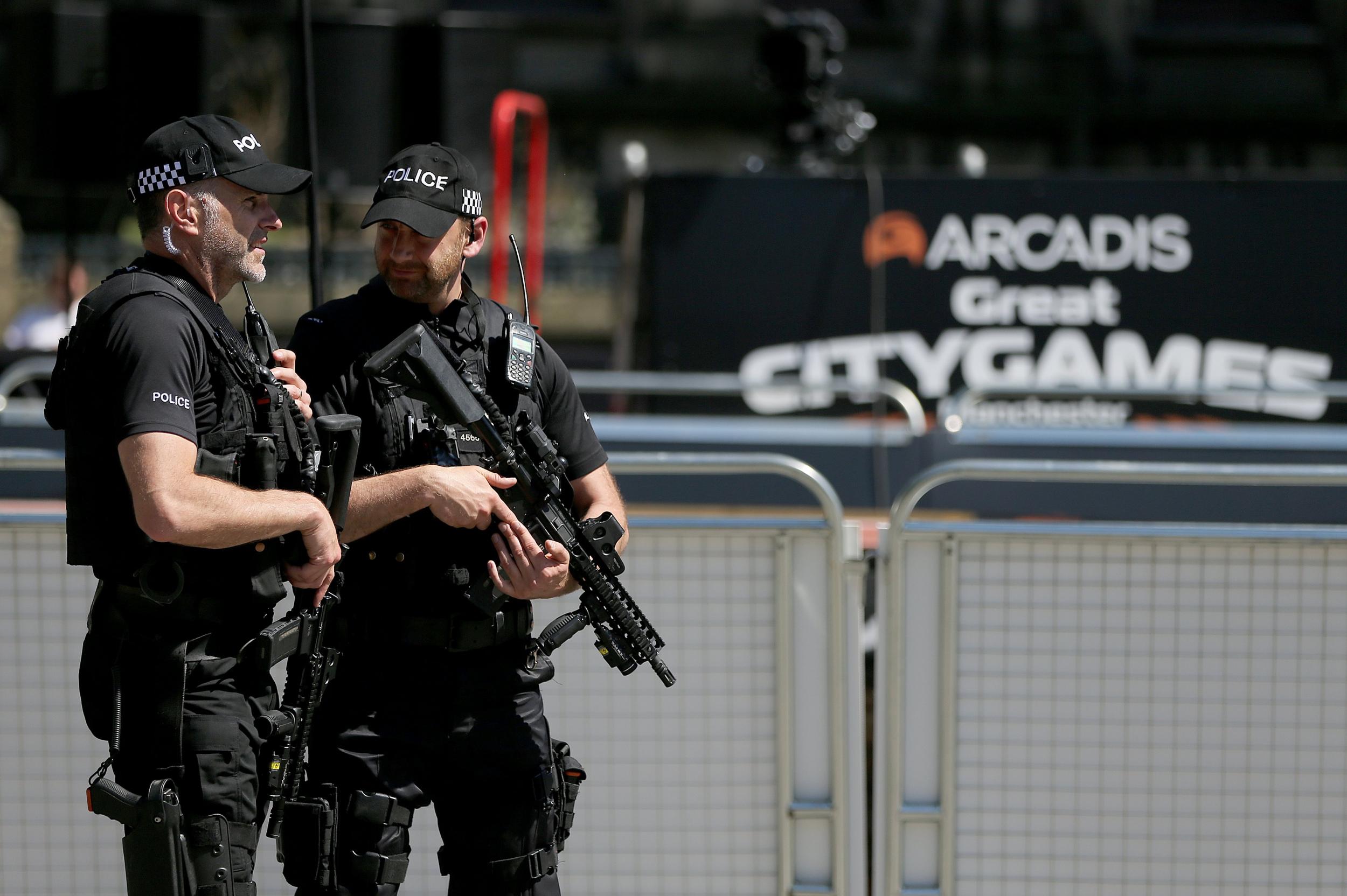 Armed police patrol the track in the centre of Manchester