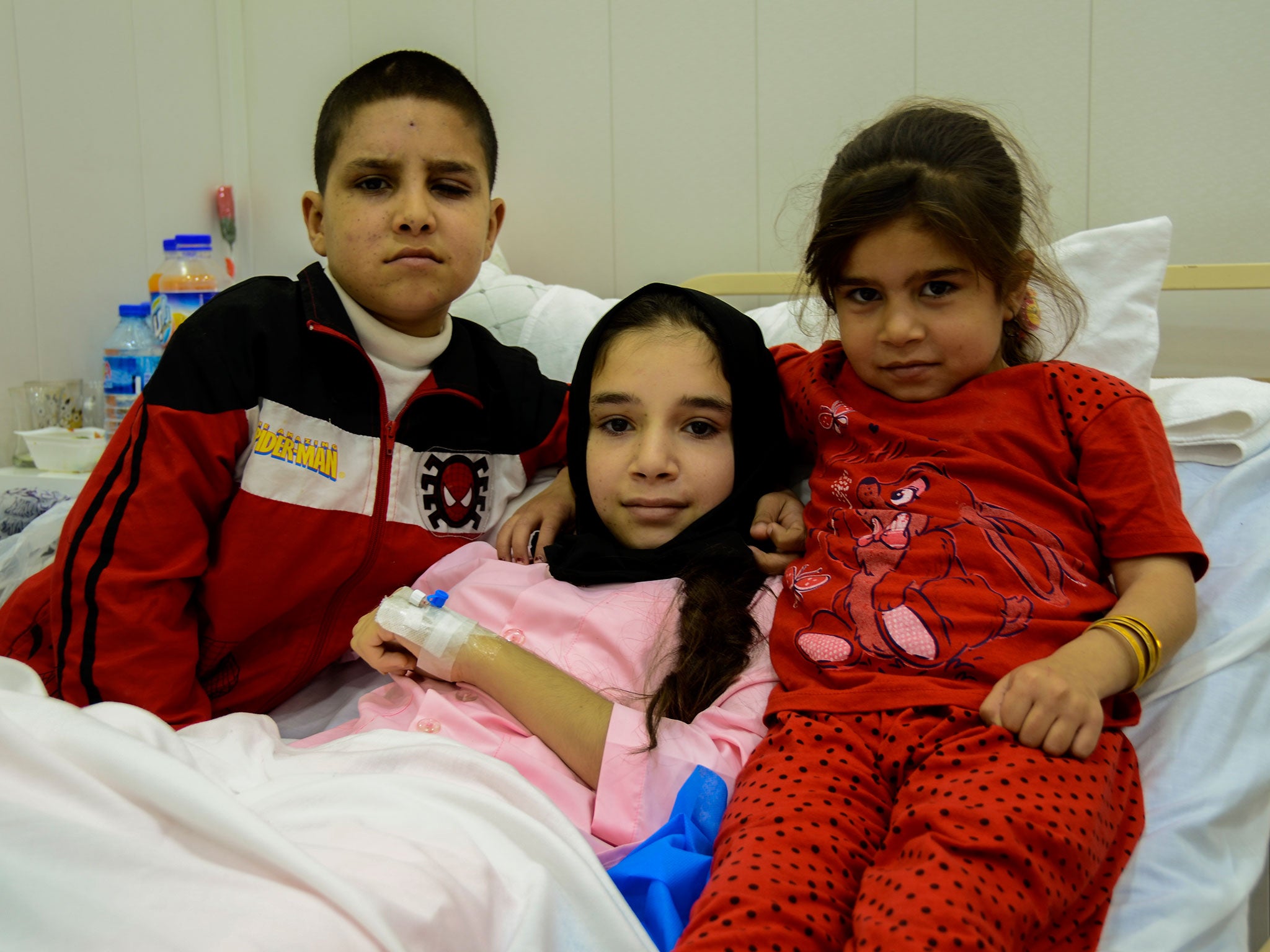 Amina (centre) with her brother and sister after the operation