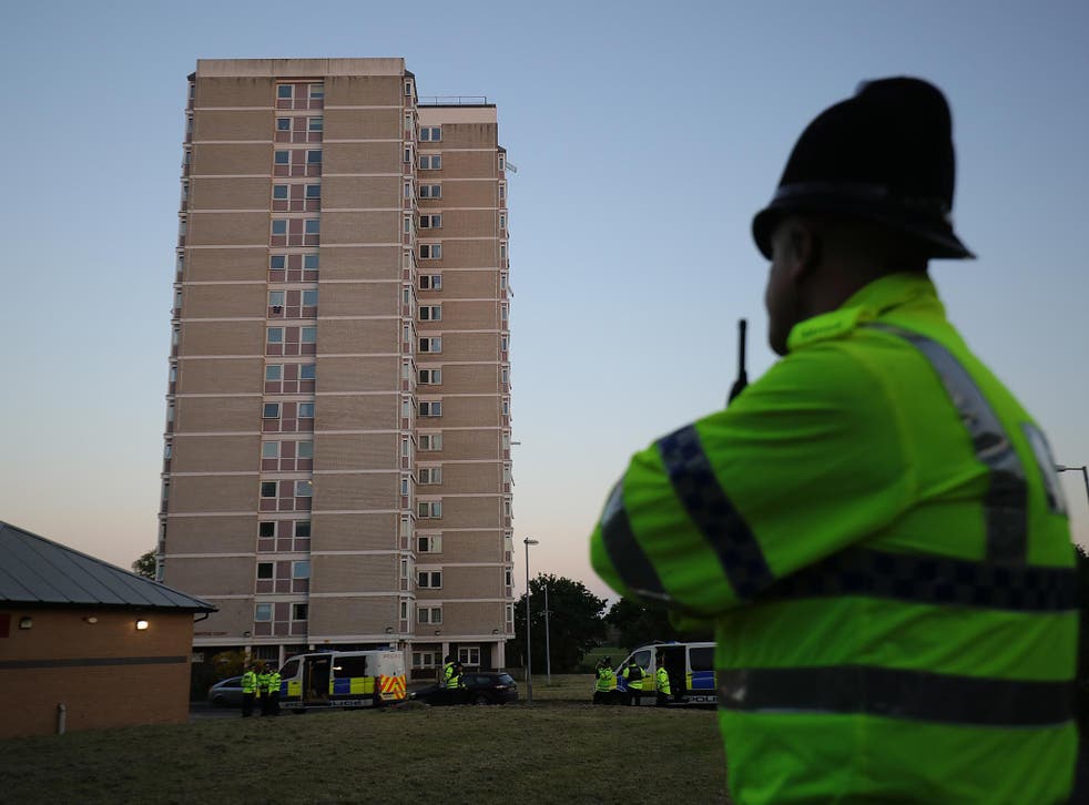Police guard the tower block flat in Blackley where Salman Abedi is thought to have constructed his bomb
