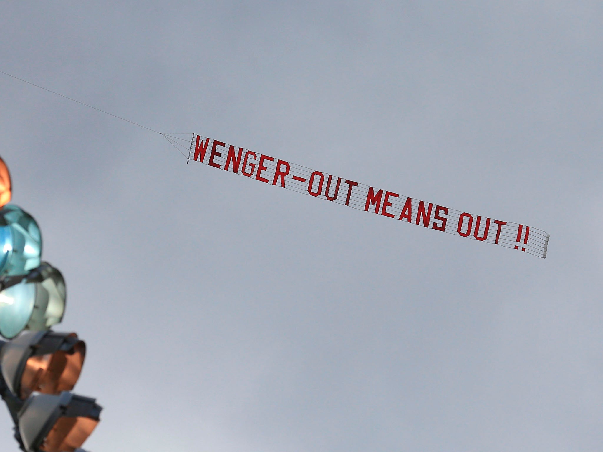 A plane was flown overhead demanding Wenger quit