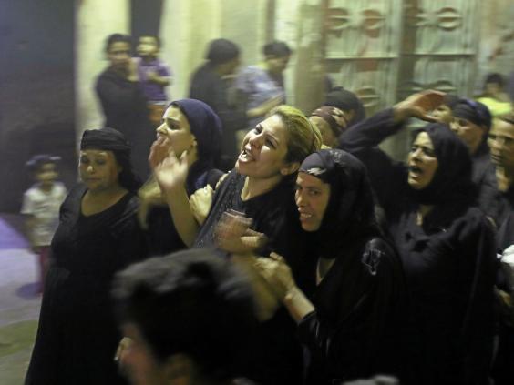 Women grieve at the funeral