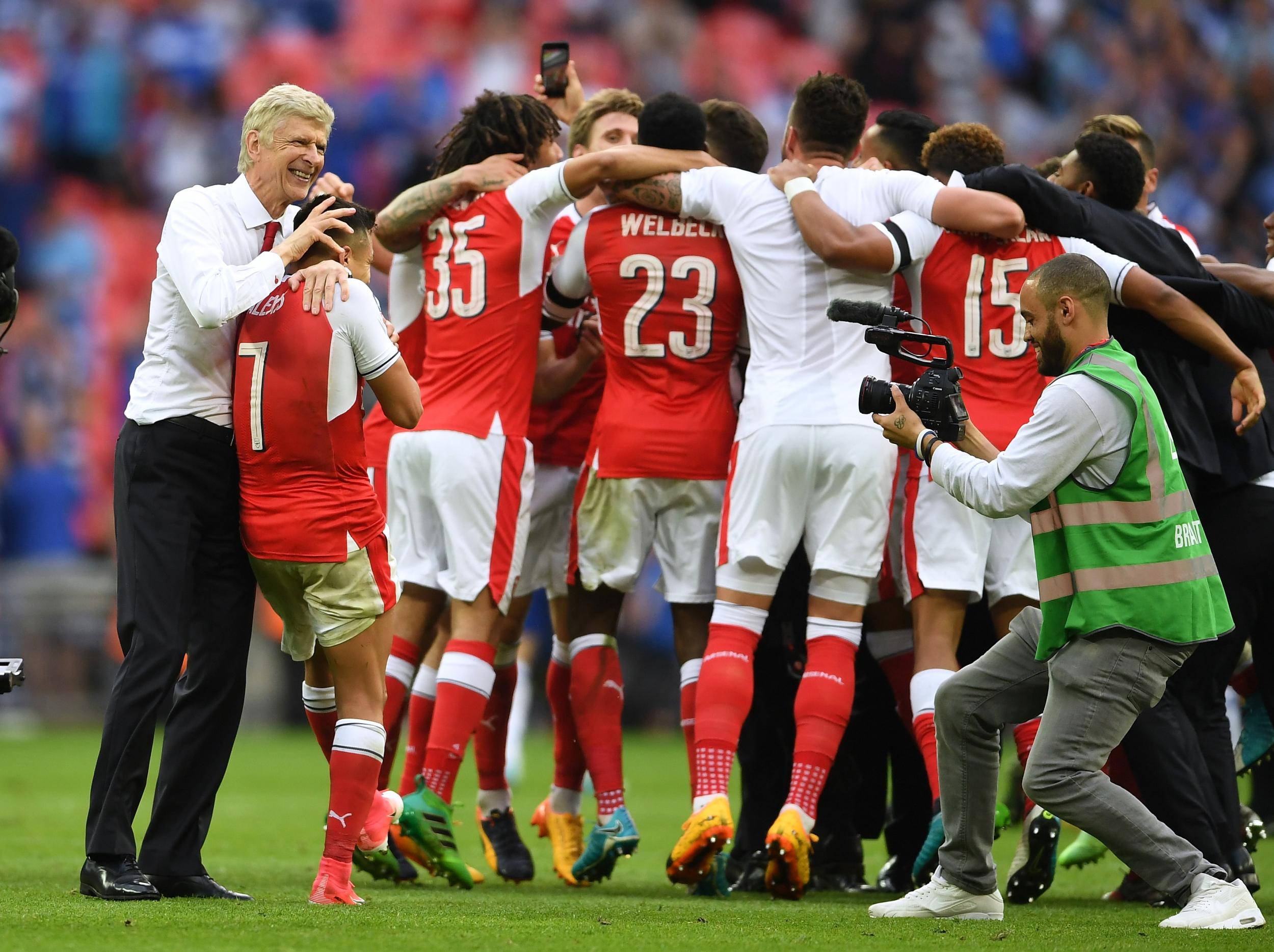 Wenger celebrates with his players after their FA Cup final victory