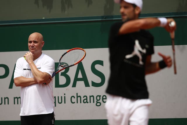 Andre Agassi watches on as Novak Djokovic trains in Paris