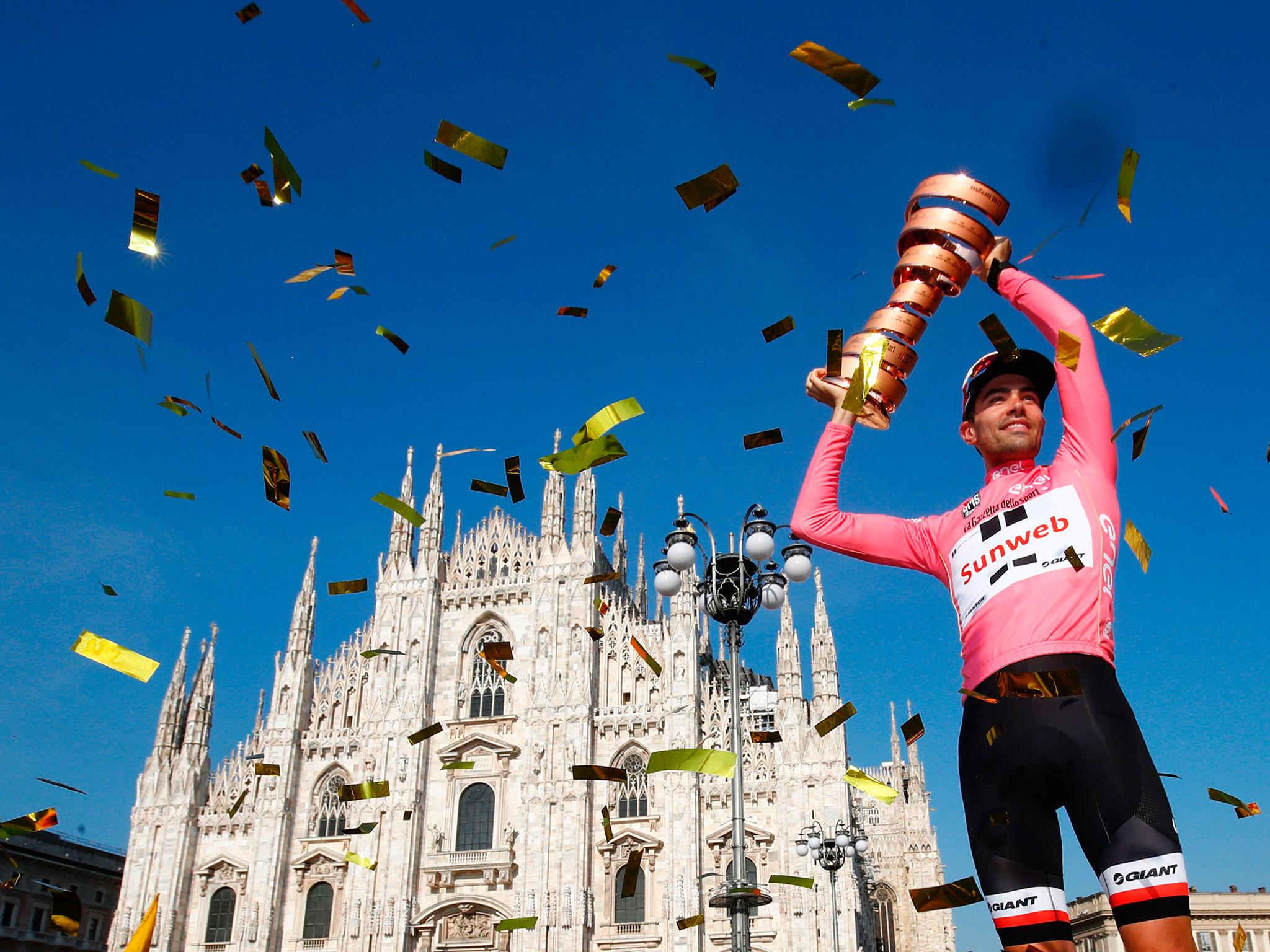 Tom Douholds lifts the trophy in the shadow of Milan's famous cathedral