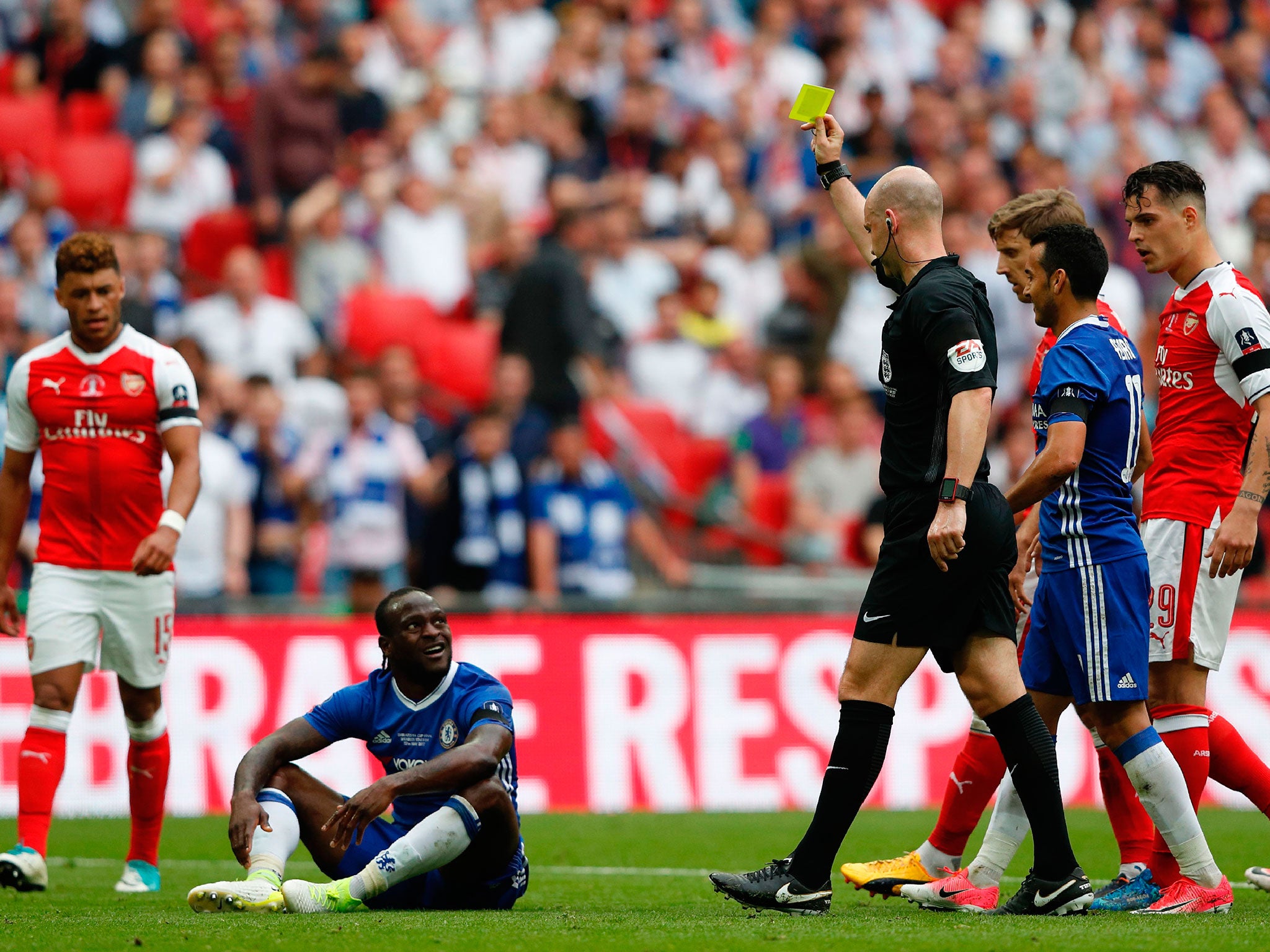 Victor Moses is shown a second yellow after diving in the Arsenal box