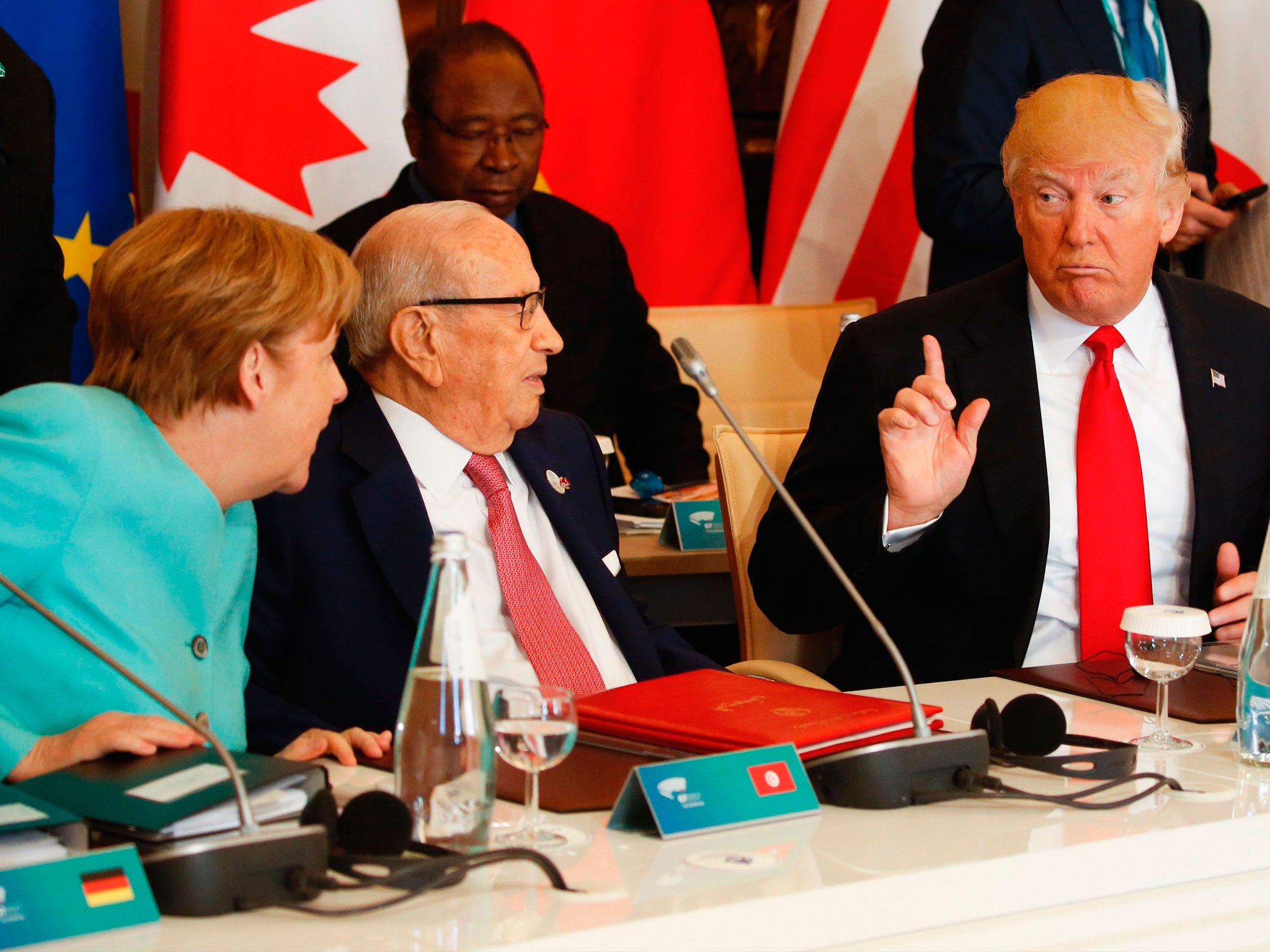 Donald Trump talks to Angela Merkel during the G7; differences emerged from the meeting in Sicily when the US President refused to commit to the Paris climate agreement